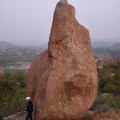 A foreigner standing near one of the stone boulders – look at the size