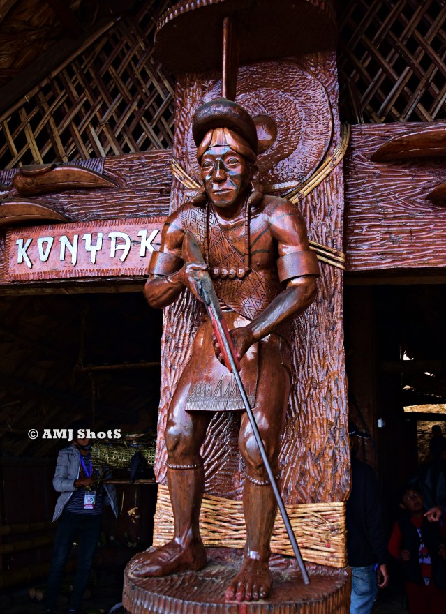 DSC_1454 Wooden sculpture of Konyak tribal hunter with gun.