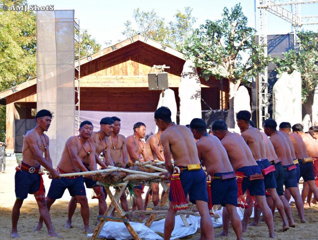 DSC_3723 Community Fishing by Sumi Ki tribe. Bark of a particular tree wood is placed on a bench above flowing river and continuously crushing it.